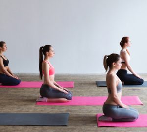 Women sitting on yoga mats