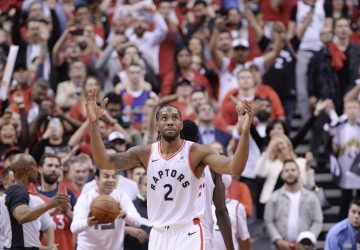 Toronto Raptors forward Kawhi Leonard reacts following the Raptors win against the Milwaukee Bucks in Game 3 of the NBA Eastern Conference finals in Toronto on Sunday, May 19, 2019. Kawhi Leonard's likeness looks down from some 10 storeys high over Yonge-Dundas Square in the heart of downtown Toronto. Arms crossed. Serious face. The tagline reads: "Fun Guy." Leonard looks anything but. And that's the appeal.