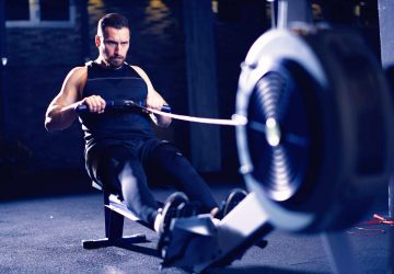 man exercising on a rowing machine