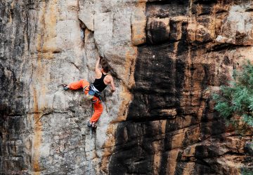 woman rock climbing in the mountains