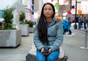 a woman meditating in public