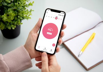 a woman using a period tracking app