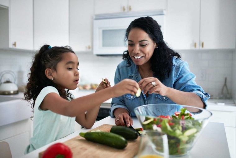 a mom and daughter eat a healthy meal