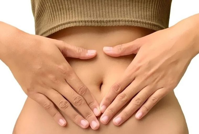 a woman with her hands on her stomach