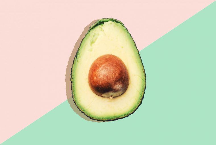 an avocado on a coloured background