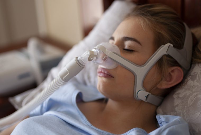 a person wearing a CPAP machine