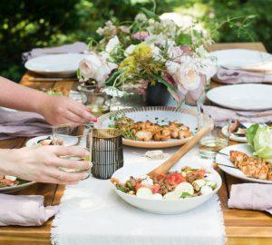 an outdoor patio table loaded with healthy foods