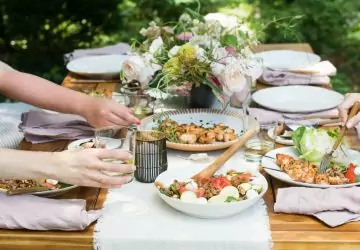 an outdoor patio table loaded with healthy foods